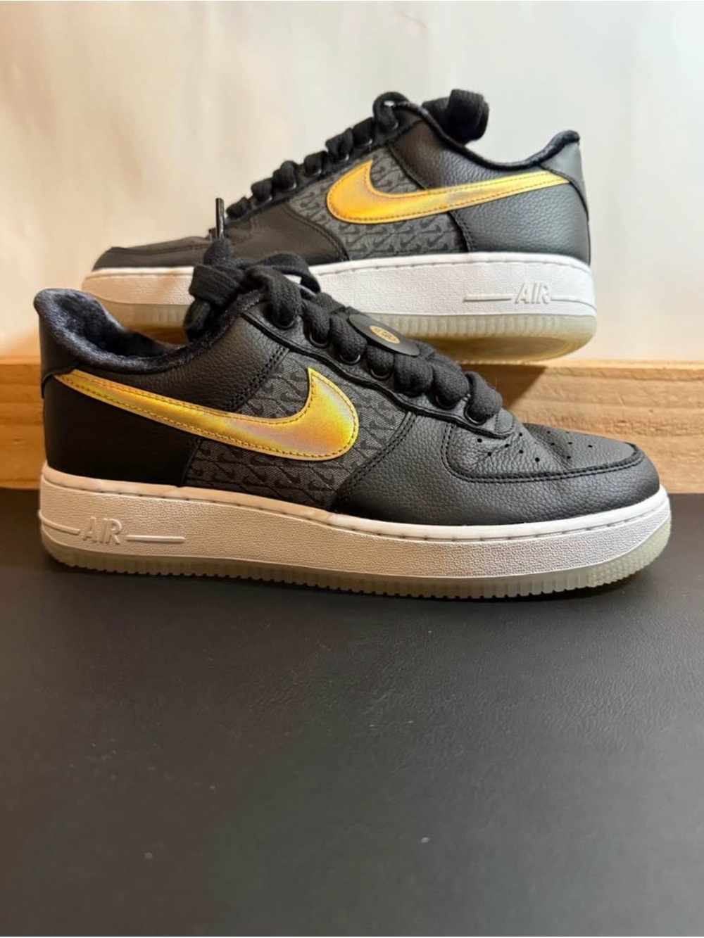 Nike Black Low-Top Sneakers with Metallic Gold Swoosh